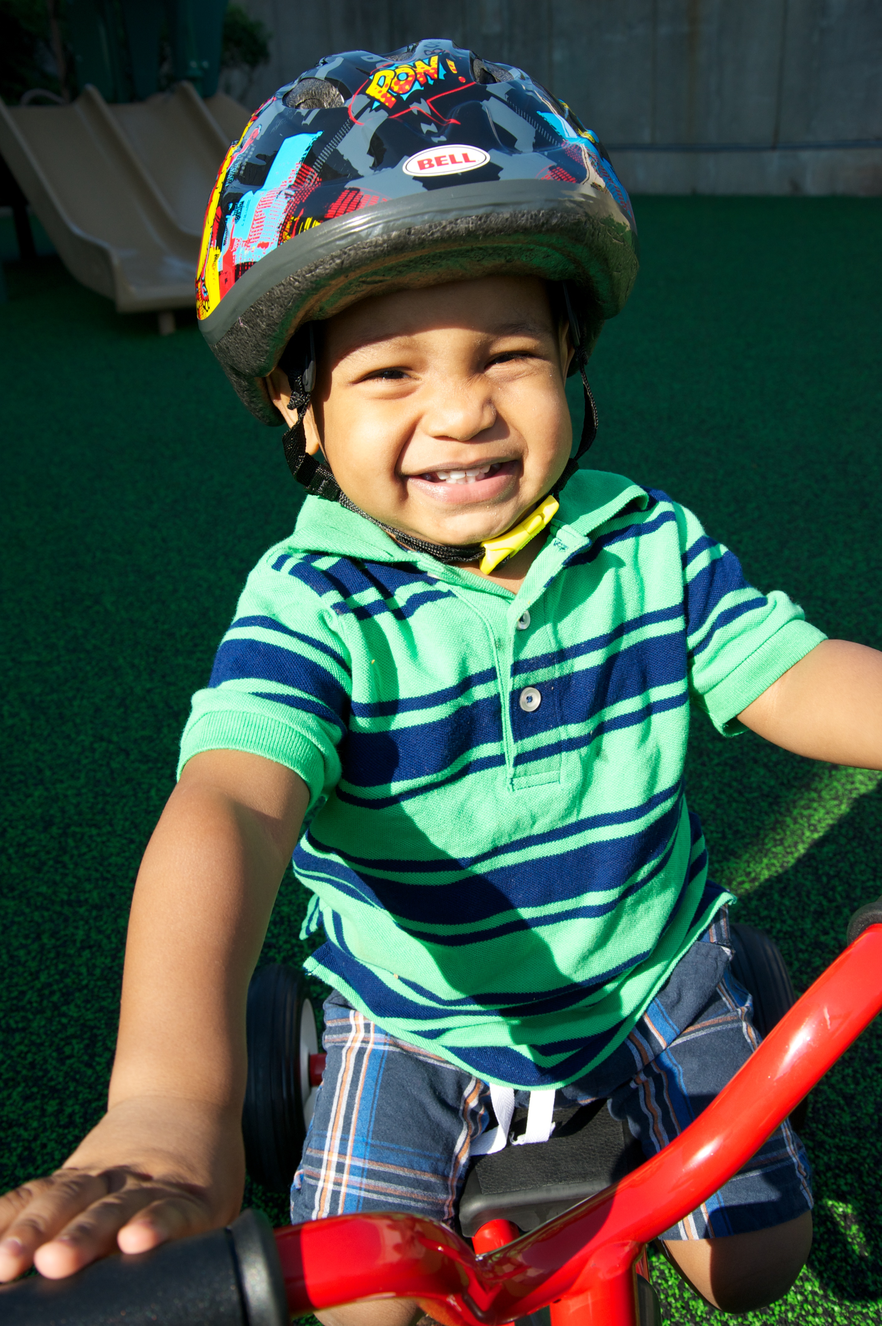 Boy wearing a helmet while riding his bicycle.