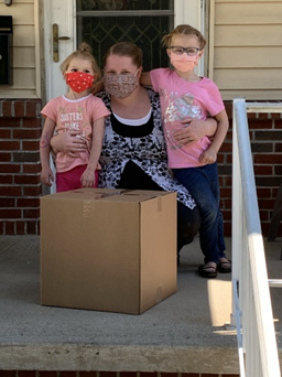 Mother with two children receiving a box.