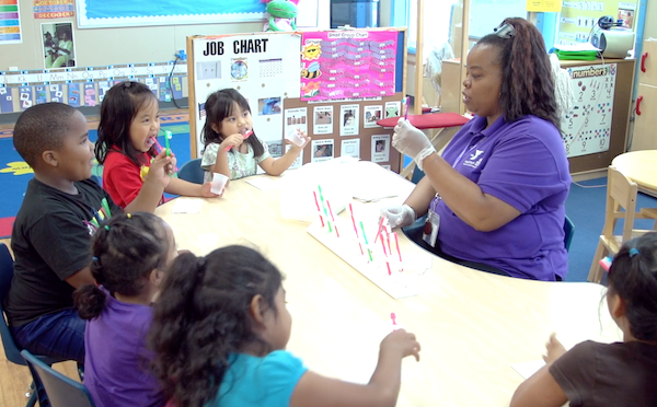 Children brushing their teeth in the classroom.