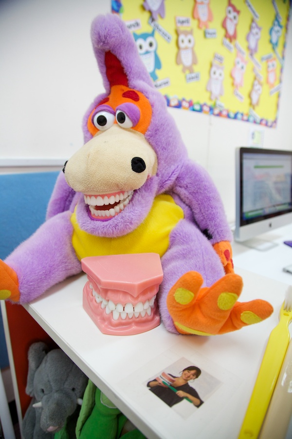 A stuffed animal with large mouthful of smiling teeth.