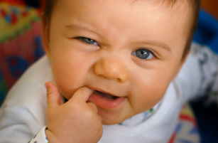 Infant smiling and winking.