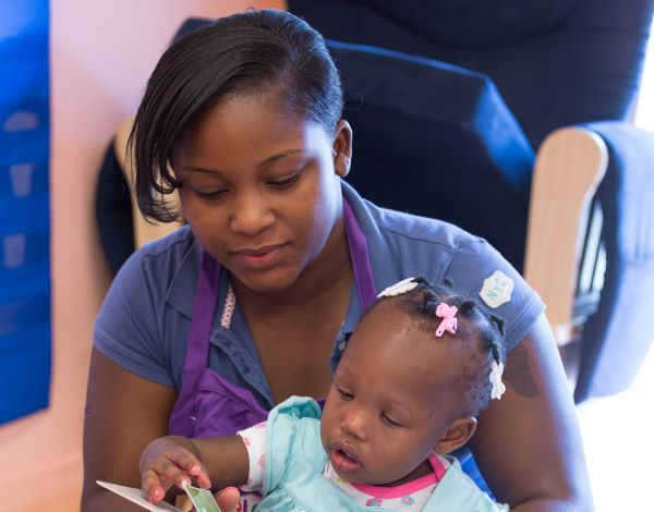 Teacher reading to a toddler.