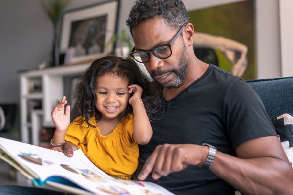 Father and daughter reading a book.