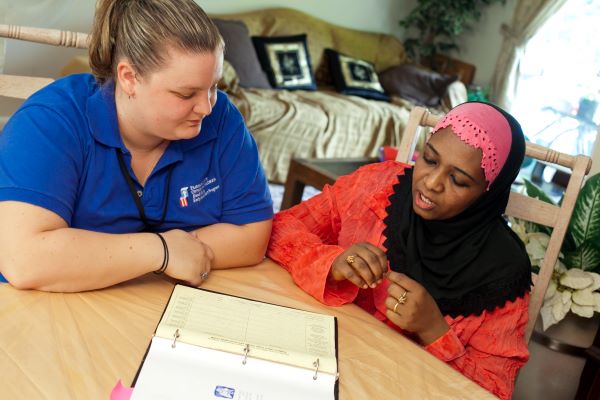 Two women going over notes.