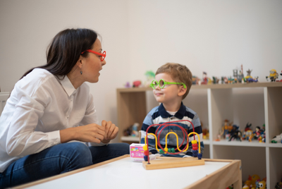 Teacher with a child in a classroom.