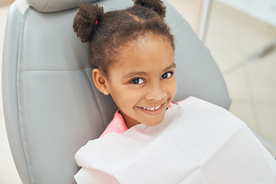 Girl smiling at a dentist's office.