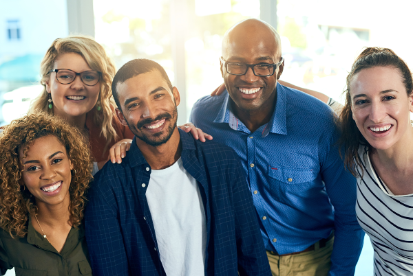 Group of smiling people posing for the camera.