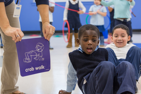 Young boy doing a crab walk.