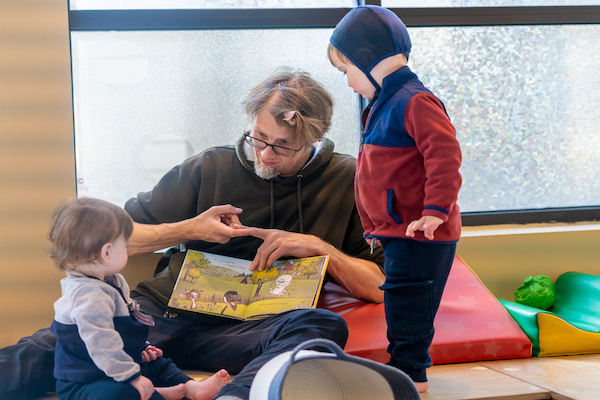 Teacher with two preschoolers in a classroom.