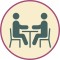 Enrollment icon of two people at a table.