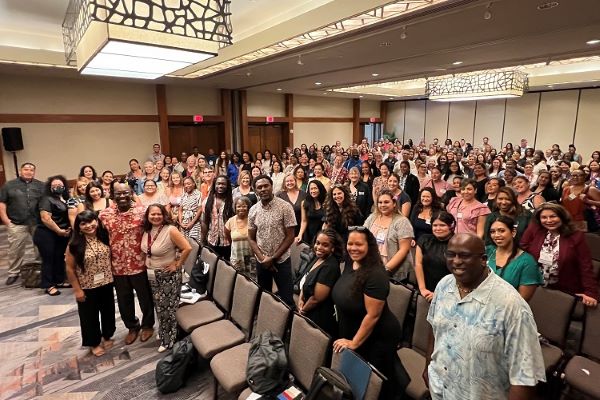 All employees receiving an orientation in a large conference room.