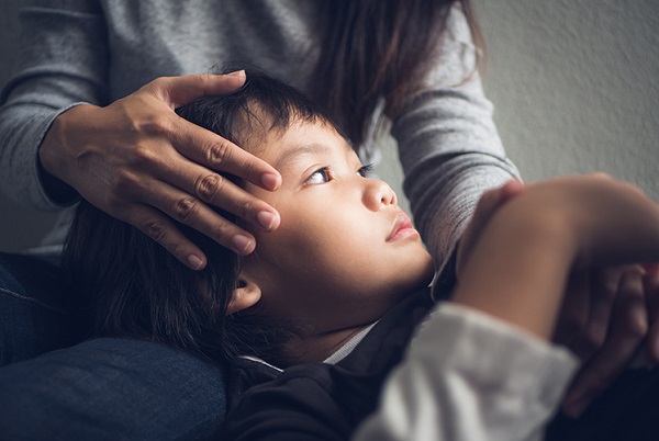 Woman comforting a distressed child.