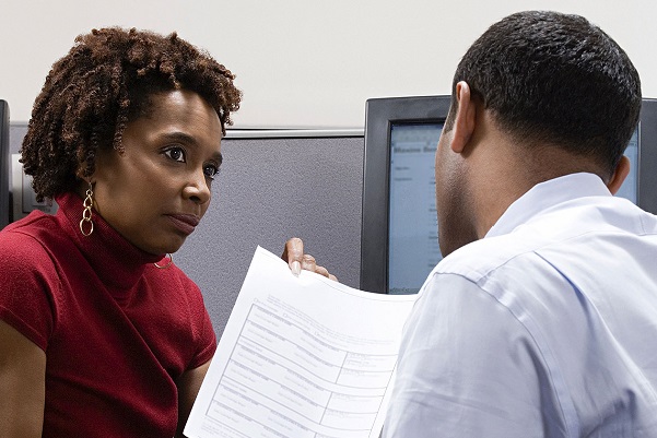 Woman sharing information with a co-worker.