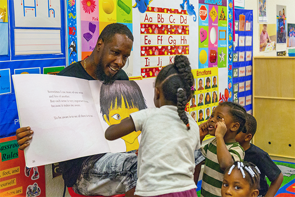 Father visiting children at a classroom.