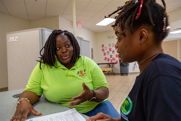 Head Start staff meeting with a parent.