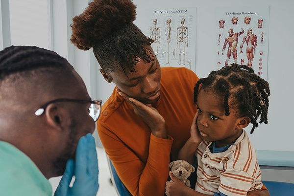 Mother with her child visiting the doctor.