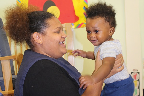 Teacher hugging a child.