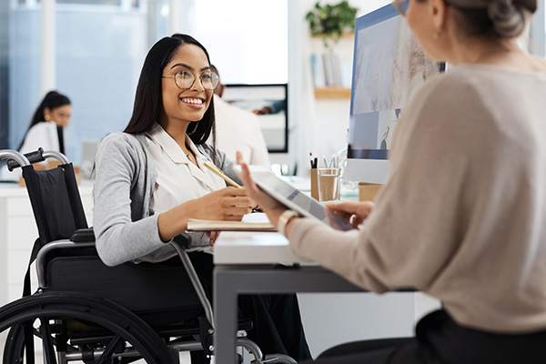 Woman in a wheelchair being interviewed.