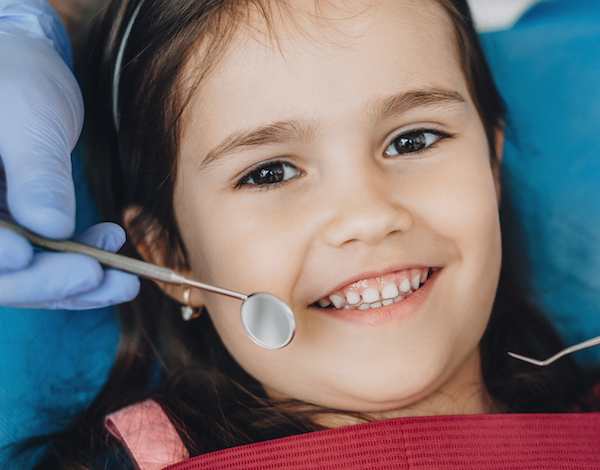 Child smiling at a dentist visit.