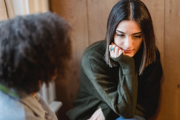 Social worker talking with a young woman.