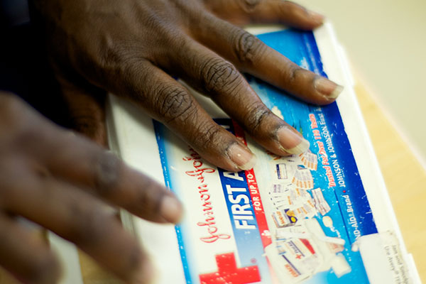 Hands holding a first aid kit.