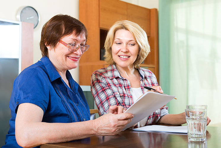 Two women meeting at a home table.