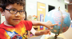 boy playing with globe