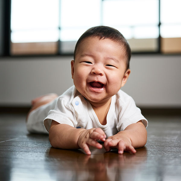 Baby on the floor laughing