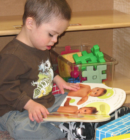 Baby reading book about babies