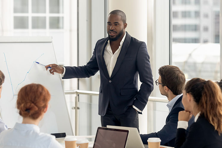 Businessman explaining progress in a chart