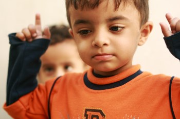 child with hands in the air