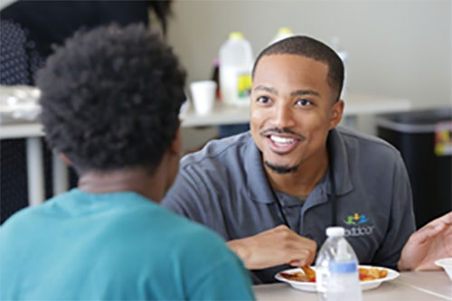 Teacher eating lunch with a student