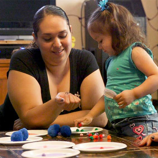 Mother helping her daughter count