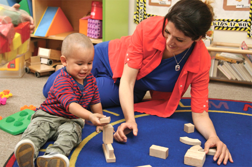 woman and child playing with blocks