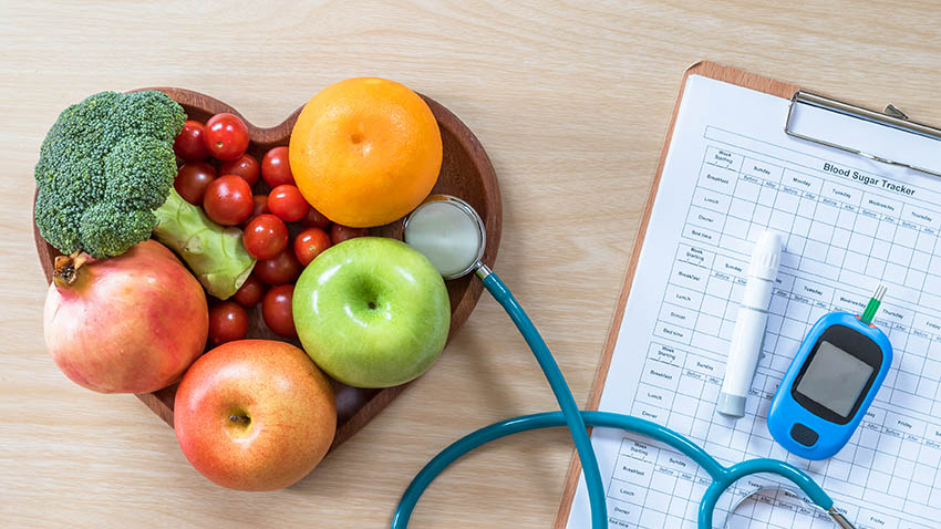 a bowl of fruit is connected to a clipboard by a stethoscope