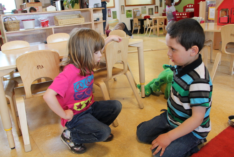 Girl and boy playing in classroom