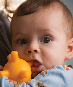 Baby chewing on a teething toy