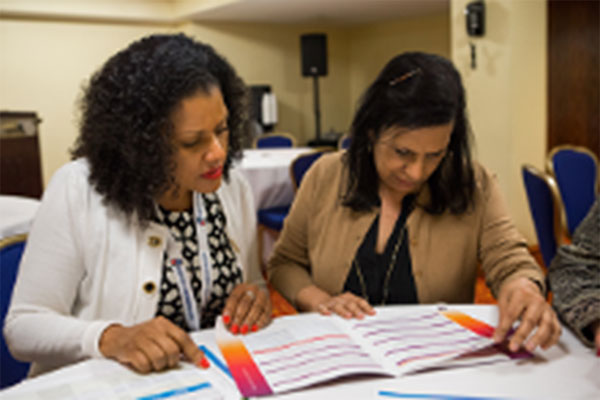 Two women going over a workbook