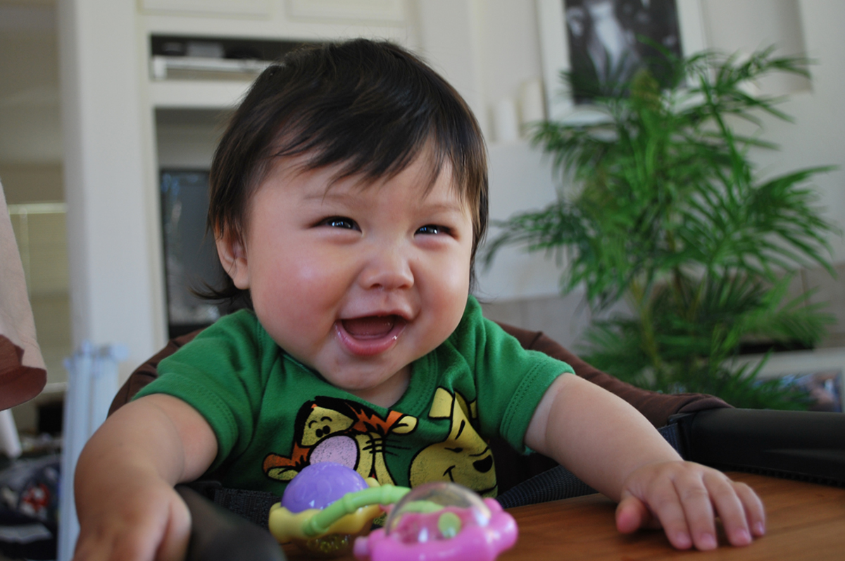 Toddler with a huge smile.