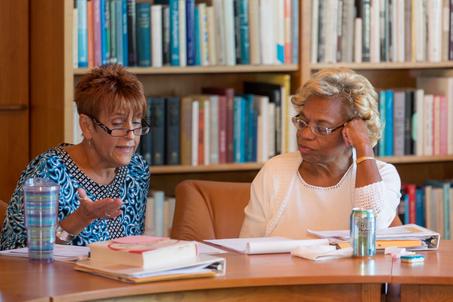 Two women going over notes.