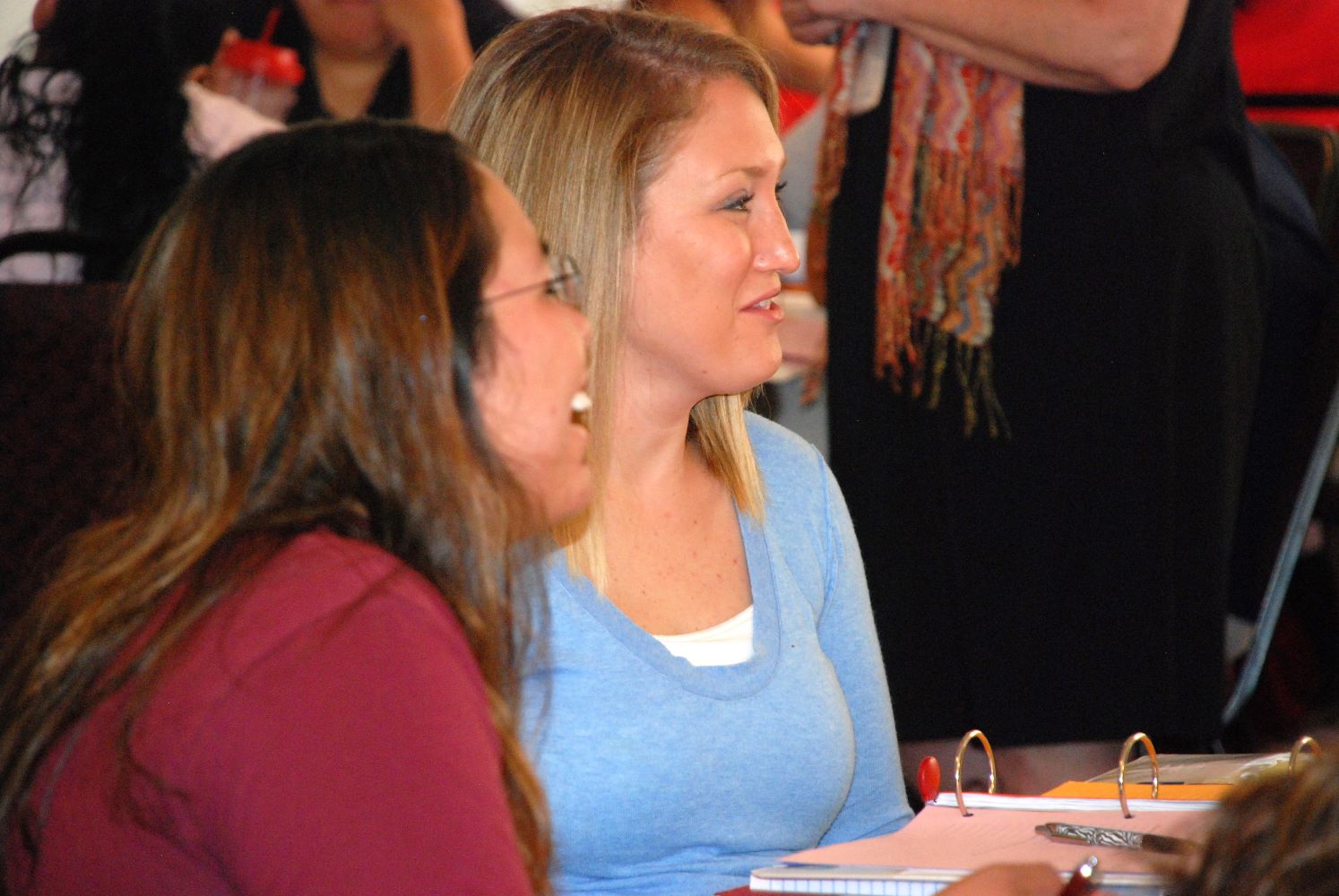 Two women sitting next to each other at a workshop.