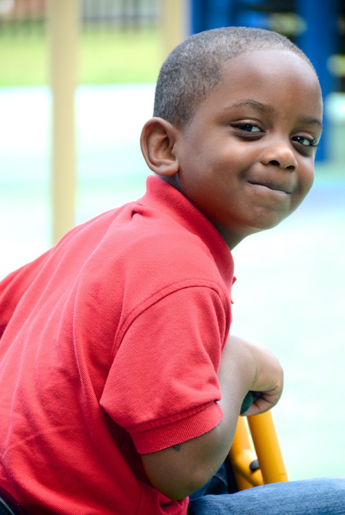 Niño sonriendo y mirando a la cámara