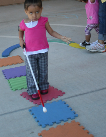 Little girl using walking stick