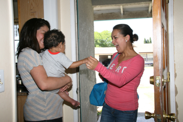 Mother with baby having professional home visit