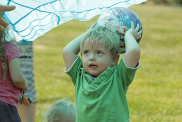 Toddler boy throwing a ball