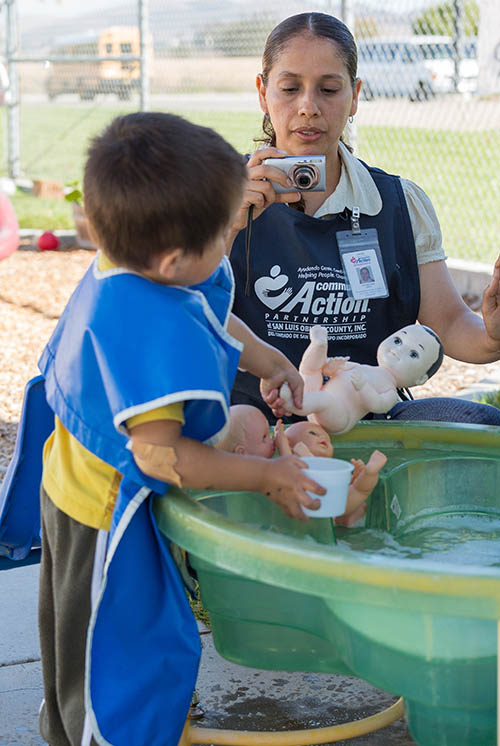 teacher uses camera to document a child's activity