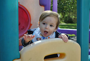 a toddler up inside some playground