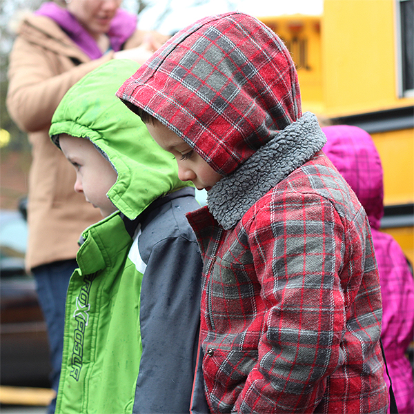 Toddler boys walking from school bus