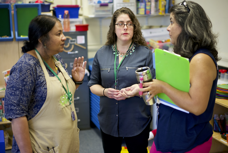 Teachers discussing in classroom