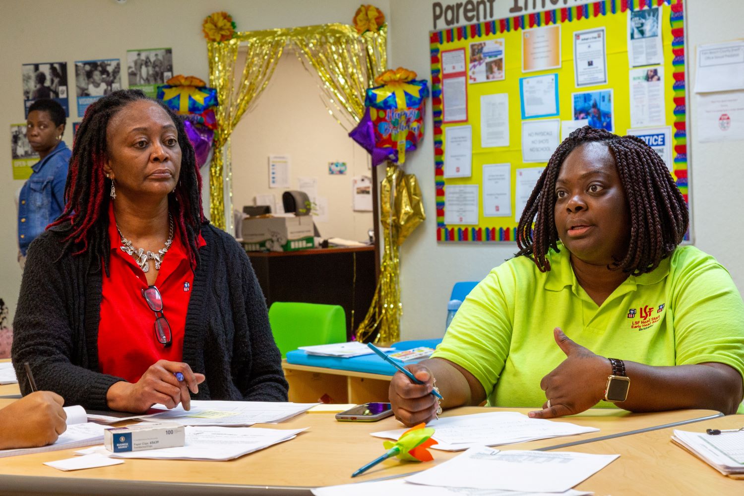 Teachers at a meeting going over notes.